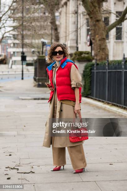 Renia Jaz wears a JW Anderson gilet, We11 Done coat, YSL shoes, Peter Doe trousers, Chanel bag, Loewe sunglasses and a Zara turtleneck top during...