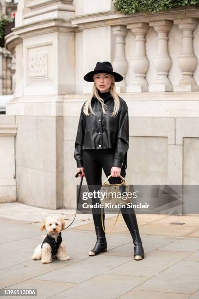 Lexi Fargo wears a Zara jacket, Intimissimi leggings, Hermes hat, Chanel earrings and boots, Valentino bag with Duke the dog wearing Prada during...