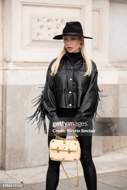 Lexi Fargo wears a Zara jacket, Intimissimi leggings, Hermes hat, Chanel earrings and a Valentino bag during London Fashion Week February 2022 on...