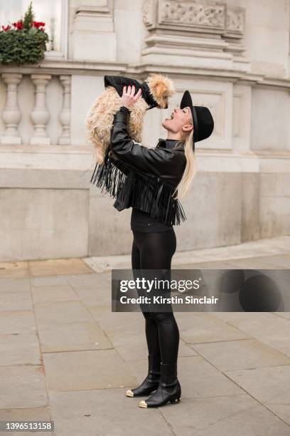 Lexi Fargo wears a Zara jacket, Intimissimi leggings, Hermes hat, Chanel earrings and boots, Valentino bag with Duke the dog wearing Prada during...