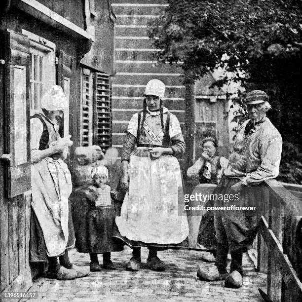 dutch family wearing traditional clothing in amsterdam, netherlands - 19th century - urban mother and daughter stock illustrations