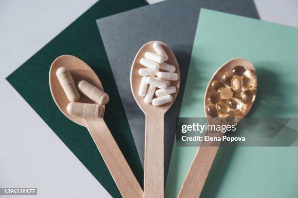 heap of nutritional supplements with vitamin d capsules for 24/7 health supporting - probiótico imagens e fotografias de stock