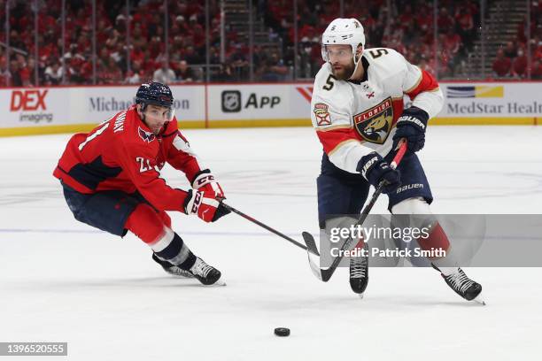 Aaron Ekblad of the Florida Panthers skates past Garnet Hathaway of the Washington Capitals during the third period in Game Four of the First Round...