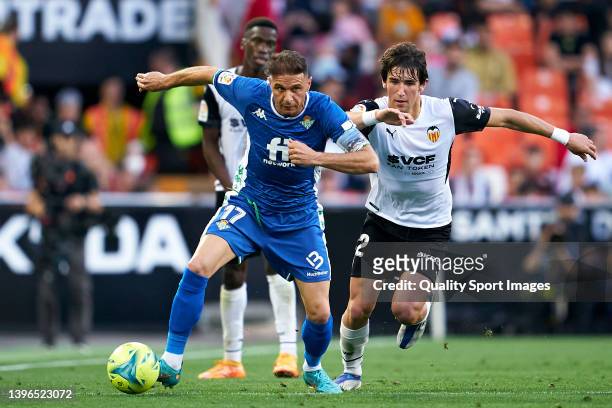 Jesus Vazquez of Valencia CF competes for the ball with Joaquin Sanchez of Real Betis during the La Liga Santander match between Valencia CF and Real...