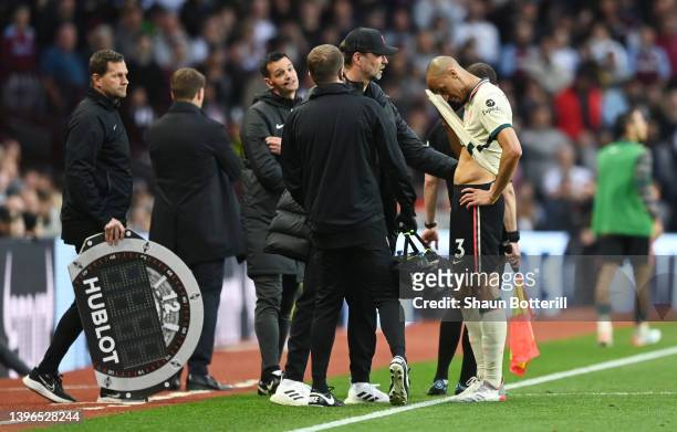 Juergen Klopp embraces Fabinho of Liverpool as they are substituted after an injury during the Premier League match between Aston Villa and Liverpool...