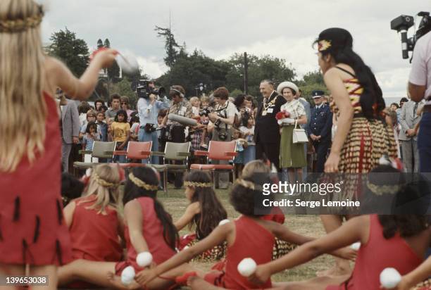 Queen Elizabeth II watches some Maori dancing during her visit to New Zealand, 1977.
