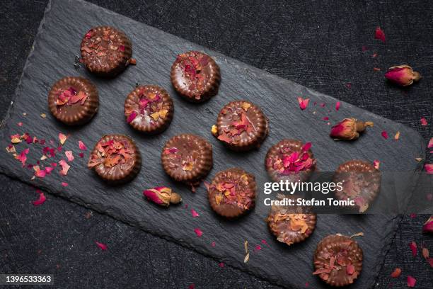 homemade pralines with rose flower petels - praline stock pictures, royalty-free photos & images