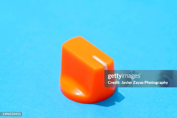 orange knob on blue background - amplifier abstract stock pictures, royalty-free photos & images