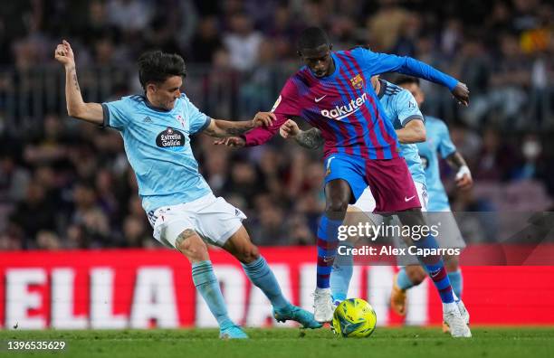 Ousmane Dembele of FC Barcelona is challenged by Franco Cervi of RC Celta de Vigo during the La Liga Santander match between FC Barcelona and RC...
