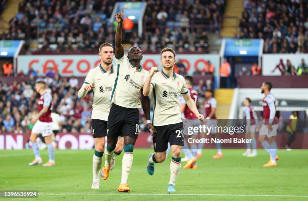 Sadio Mane celebrates with teammates Jordan Henderson and Diogo Jota of Liverpool after scoring their team's second goal during the Premier League...