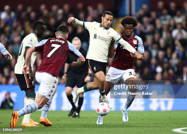 Thiago Alcantara of Liverpool is challenged by Carney Chukwuemeka of Aston Villa during the Premier League match between Aston Villa and Liverpool at...
