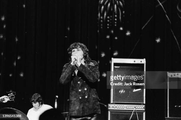 American Rock singer Jim Morrison , of the group the Doors, performs onstage at Town Hall, Philadelphia, Pennsylvania, June 18, 1967. Visible in the...