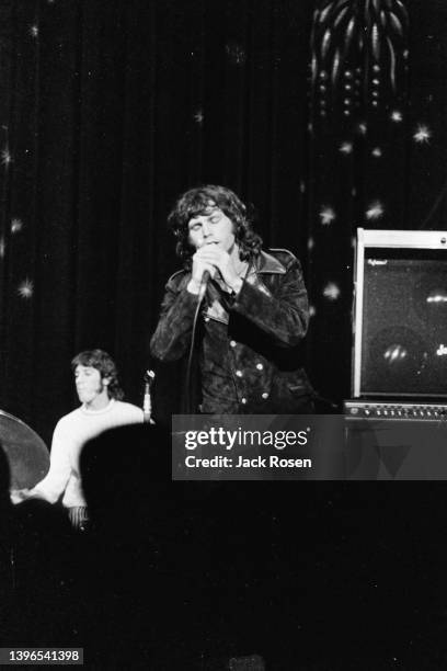 American Rock singer Jim Morrison , of the group the Doors, performs onstage at Town Hall, Philadelphia, Pennsylvania, June 18, 1967. Visible in the...
