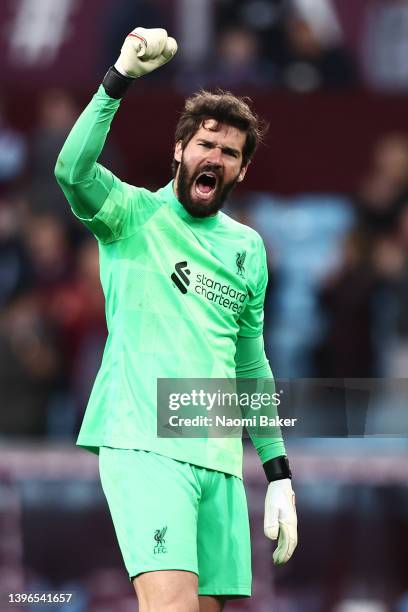 Alisson Becker of Liverpool acknowledges the fans after their sides victory during the Premier League match between Aston Villa and Liverpool at...