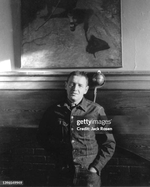 Portrait of American artist Andrew Wyeth as he poses in front of a fireplace in his home, Chadds Ford, Pennsylvania, winter 1959.