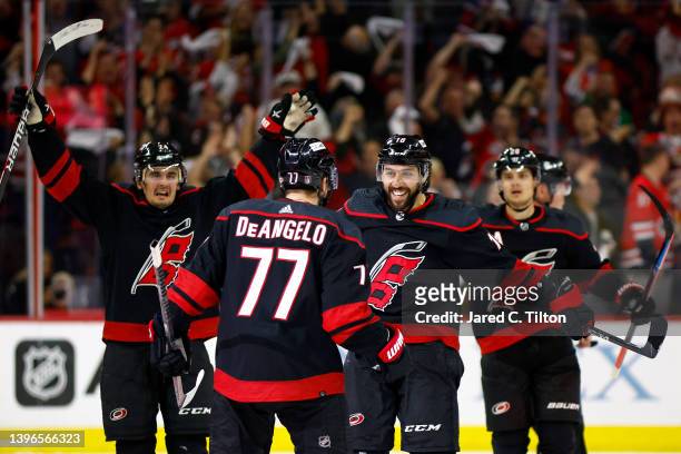 Tony DeAngelo of the Carolina Hurricanes celebrates with his team following his first period goal against the Boston Bruins in Game Five of the First...