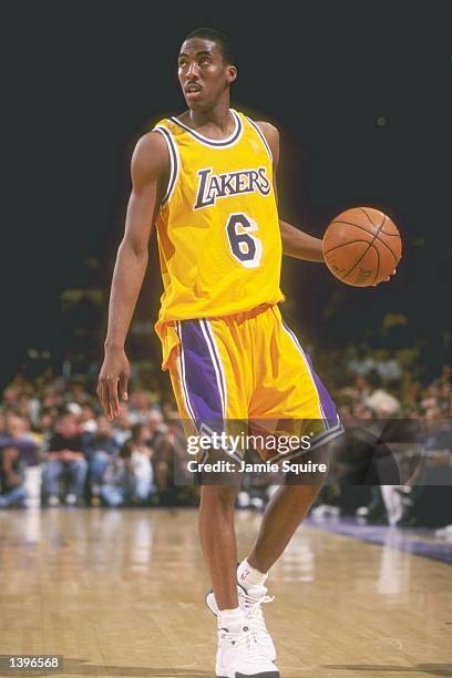 Guard Eddie Jones of the Los Angeles Lakers dribbles the ball down the court during a game against the Phoenix Suns at the Great Western Forum in...