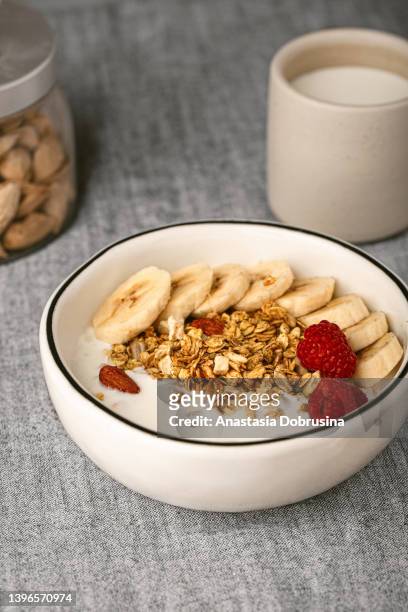 smoothie bowl topped with fresh berries and granola - oatmeal stock pictures, royalty-free photos & images