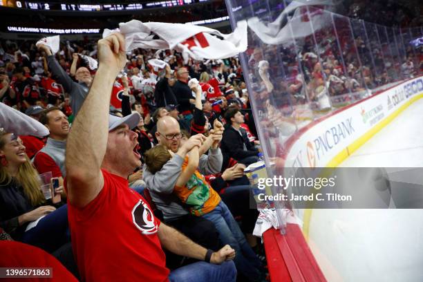 Fans cheer following a Carolina Hurricane's second period goal against the Boston Bruins in Game Five of the First Round of the 2022 Stanley Cup...