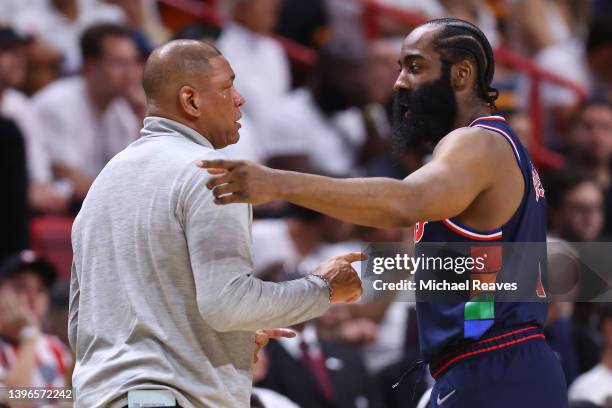James Harden of the Philadelphia 76ers talks with head coach Doc Rivers against the Miami Heat during the first half in Game Five of the Eastern...