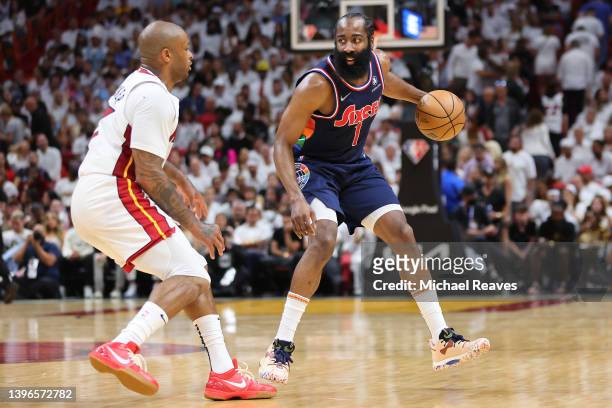 James Harden of the Philadelphia 76ers dribbles against P.J. Tucker of the Miami Heat during the first half in Game Five of the Eastern Conference...