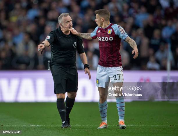 Referee Jon Moss talks with Lucas Digne of Aston Villa during the Premier League match between Aston Villa and Liverpool at Villa Park on May 10,...