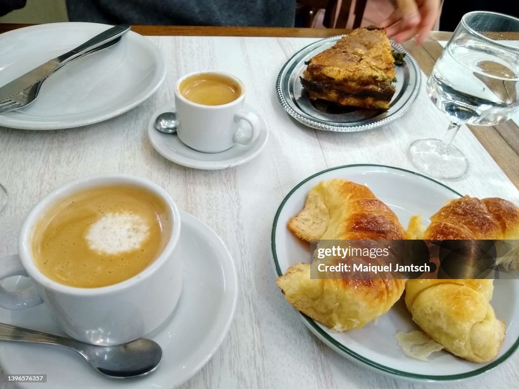 A traditional breakfast argentinian breakfast with coffee and medialunas