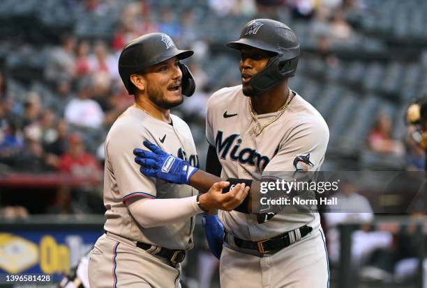 Jorge Soler of the Miami Marlins celebrates with Miguel Rojas after hitting a two run home run off of Madison Bumgarner of the Arizona Diamondbacks...