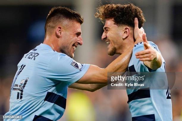 Marinos Tzionis of Sporting Kansas City celebrates scoring the game-tying goal with Rémi Walter against FC Dallas, sending the game into extra time...