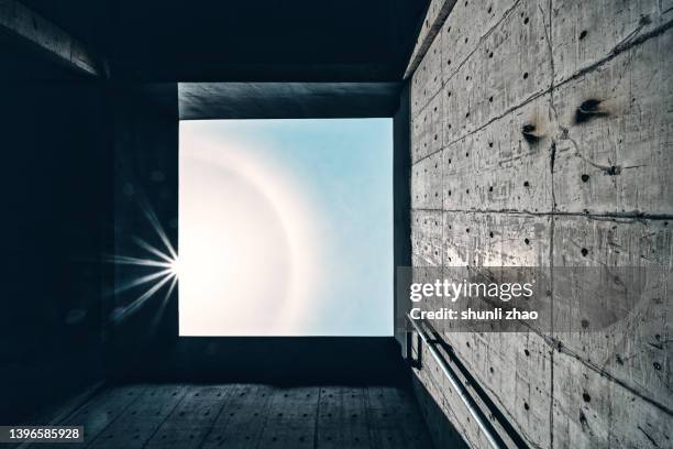 low angle view of concrete wall against sky - every cloud has a silver lining stock pictures, royalty-free photos & images