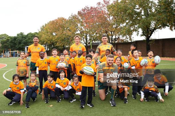 Lalakai Foketi, Michael Hooper, Noah Lolesio and Lachlan Swinton of the Wallabies pose with school children during a media opportunity as the...