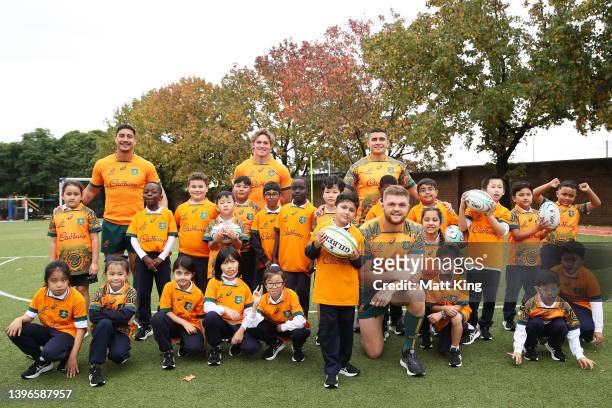 Lalakai Foketi, Michael Hooper, Noah Lolesio and Lachlan Swinton of the Wallabies pose with school children during a media opportunity as the...