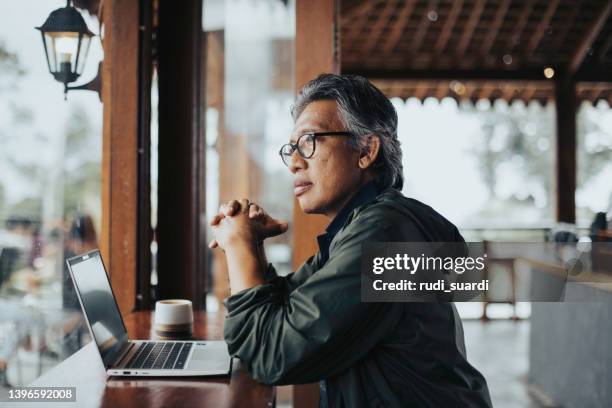 businessman sitting in cafe, working - man looking through window stock pictures, royalty-free photos & images