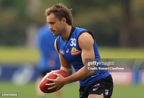 Lachlan McNeil of the Bulldogs controls the ballduring a Western Bulldogs AFL training session at Whitten Oval on May 11, 2022 in Melbourne,...