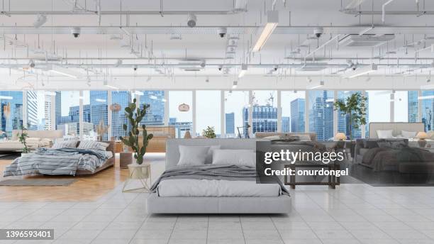 showroom de muebles con diferentes muebles de cama, plantas en macetas y mesas auxiliares. paisaje urbano desde la ventana. - sala de muestras fotografías e imágenes de stock