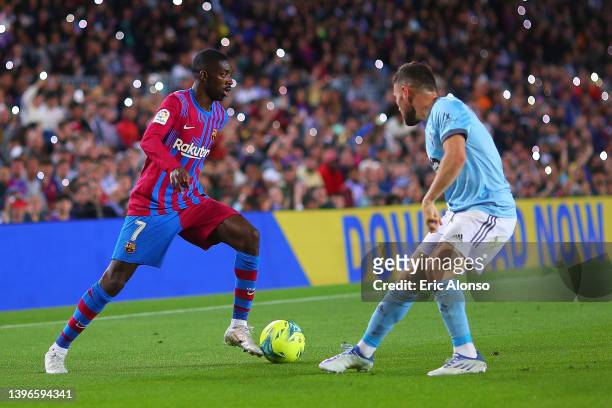 Ousmane Dembele of FC Barcelona challenges for the ball against Javi Galan of Celta de Vigo during the La Liga Santader match between FC Barcelona...