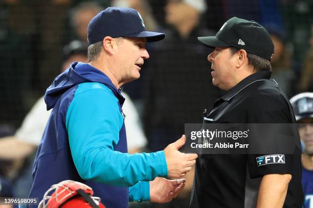 Manager Scott Servais of the Seattle Mariners speaks with umpire Doug Eddings after a strike three called on Luis Torrens of the Seattle Mariners...