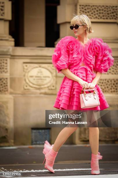 Violet Grace Atkinson wearing Aje dress, Gucci bag and Christian Louboutin pink lace heels at Afterpay Australian Fashion Week 2022 on May 11, 2022...