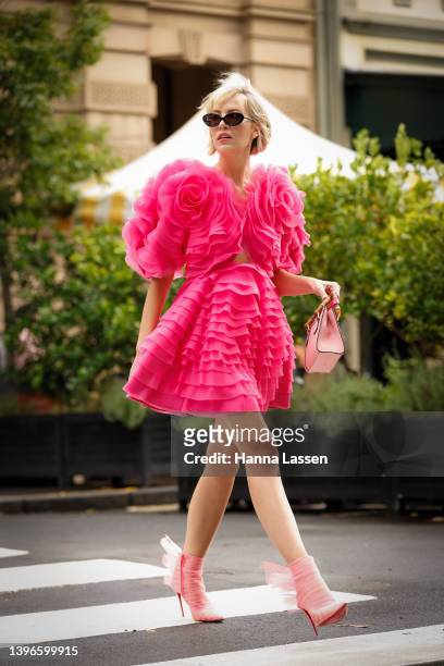 Violet Grace Atkinson wearing Aje dress, Gucci bag and Christian Louboutin pink lace heels at Afterpay Australian Fashion Week 2022 on May 11, 2022...