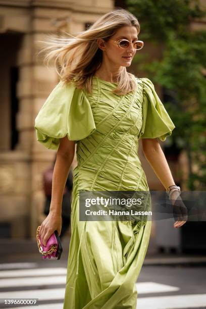 Kate Waterhouse wearing green maxi Aje dress and pink Louis Vuitton clutch at Afterpay Australian Fashion Week 2022 on May 11, 2022 in Sydney,...