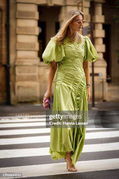 Kate Waterhouse wearing green maxi Aje dress and pink Louis Vuitton clutch at Afterpay Australian Fashion Week 2022 on May 11, 2022 in Sydney,...