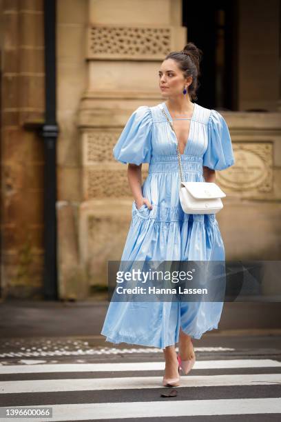 Olympia Valance wearing Aje blue dress and Burberry ivory bag at Afterpay Australian Fashion Week 2022 on May 11, 2022 in Sydney, Australia.