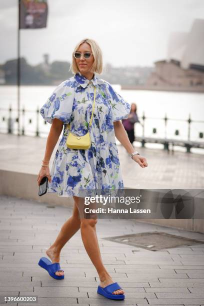 Suzy Eskander wearing blue Aje dress and Prada mini yellow bag at Afterpay Australian Fashion Week 2022 on May 11, 2022 in Sydney, Australia.