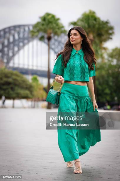 Ashton Wood wearing green Aje dress and green Louis Vuitton leather bag at Afterpay Australian Fashion Week 2022 on May 11, 2022 in Sydney, Australia.