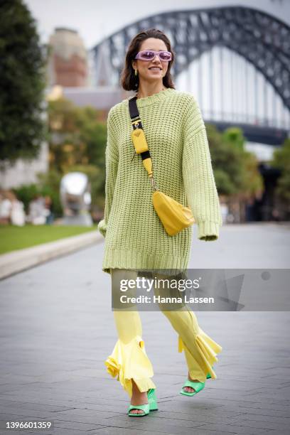 Maxine Wylde wearing Aje Raine Oversized Knit Jumper, yellow Prada bag and Attico neon green shoes at Afterpay Australian Fashion Week 2022 on May...