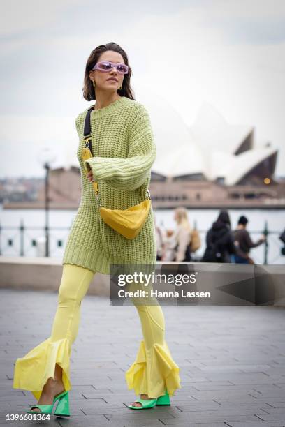 Maxine Wylde wearing Aje Raine Oversized Knit Jumper, yellow Prada bag and Attico neon green shoes at Afterpay Australian Fashion Week 2022 on May...