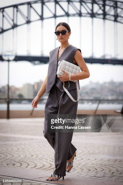Holly Titheridge wearing Camilla and Marc vest and pants, Bottega Veneta white clutch at Afterpay Australian Fashion Week 2022 on May 11, 2022 in...