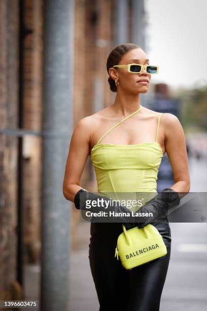 Kirsty Sturgess wearing green top and neon yellow Balenciaga bag at Afterpay Australian Fashion Week 2022 on May 11, 2022 in Sydney, Australia.