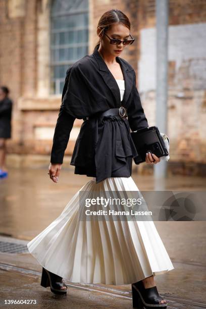 Cai wearing Dion lee dress in white, Yen club Black vintage blazer, Valentino sunglasses, Glowmesh bag, Stuart weitzman heels at Afterpay Australian...