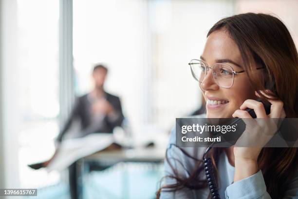 business call - landline phone woman stock pictures, royalty-free photos & images